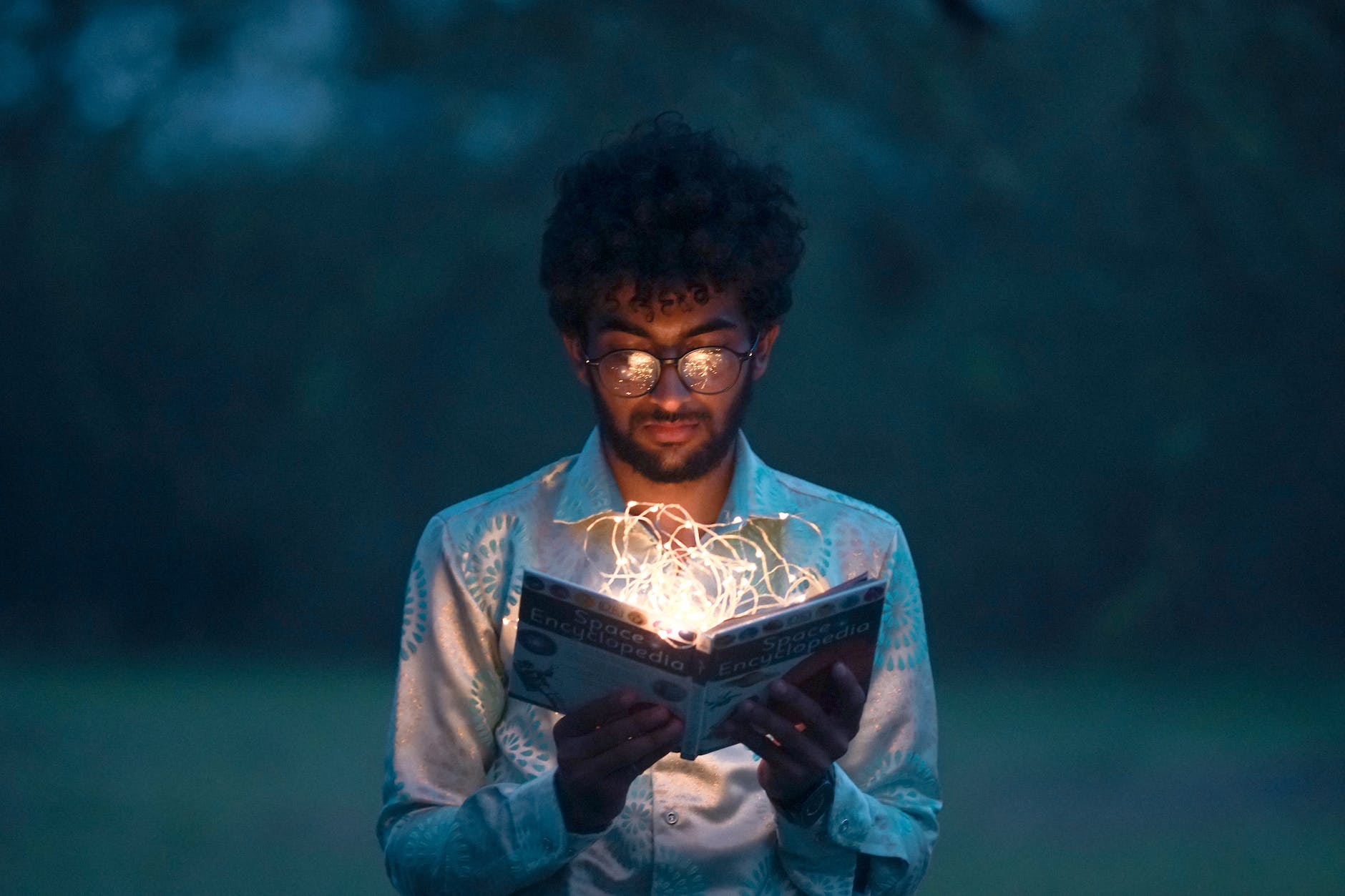 man holding book blogging as a doctor medical blog