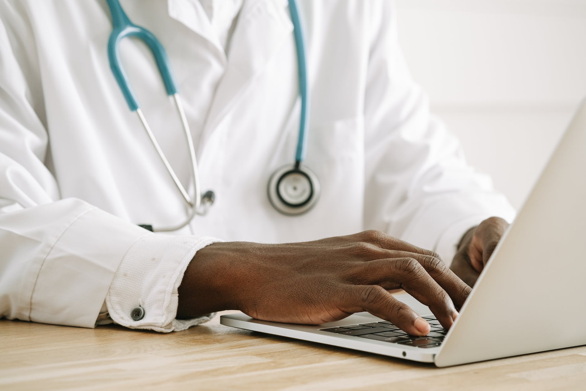 a medical blogging doctor typing on a laptop